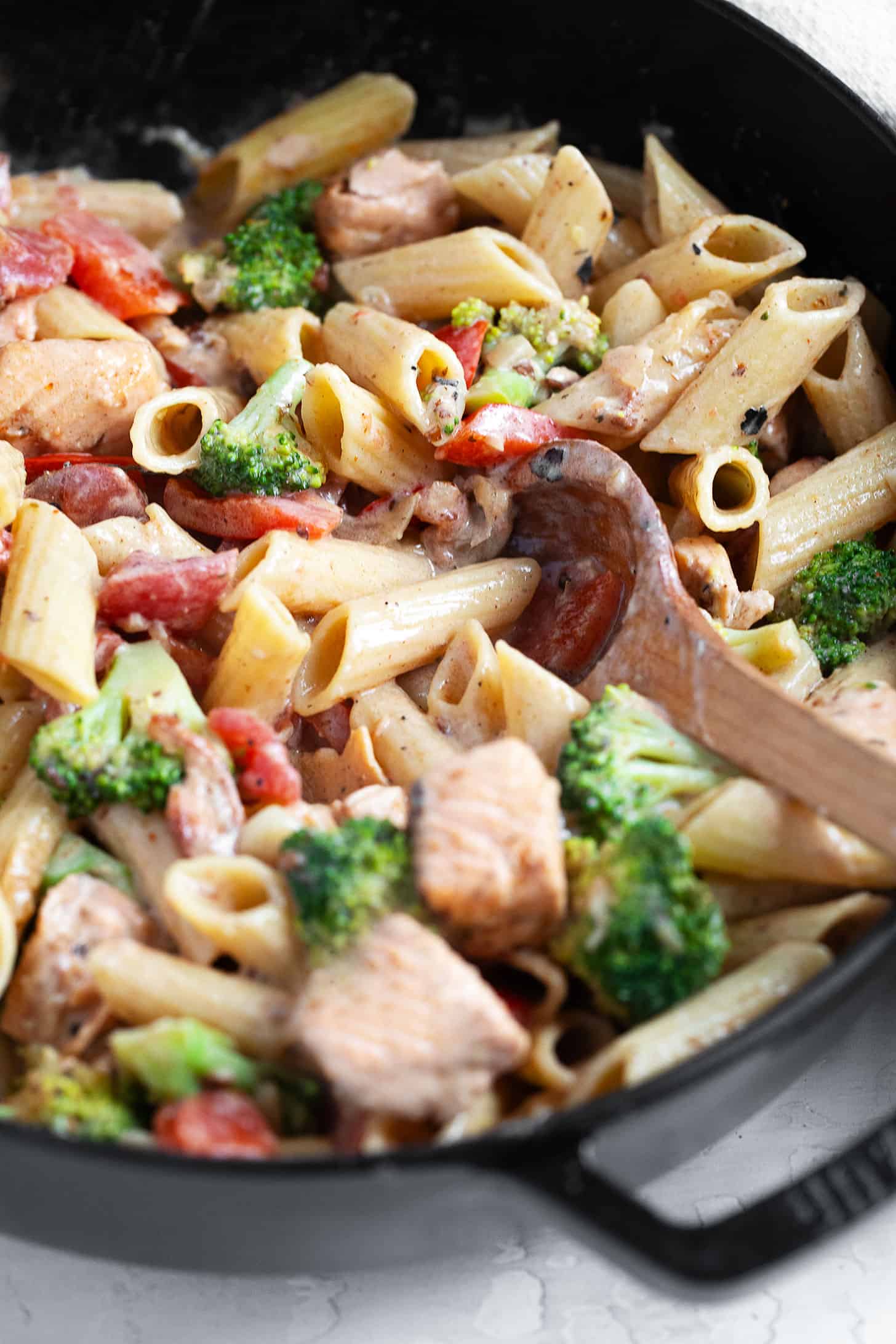Cajun salmon pasta in a cast-iron skillet.