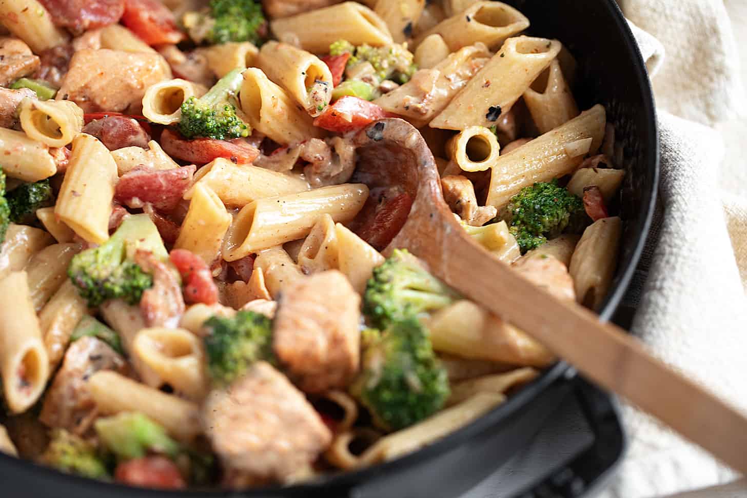 Cajun salmon pasta in a cast-iron skillet.