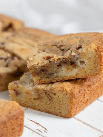 Cinnamon roll blondies cut on a wooden serving board.