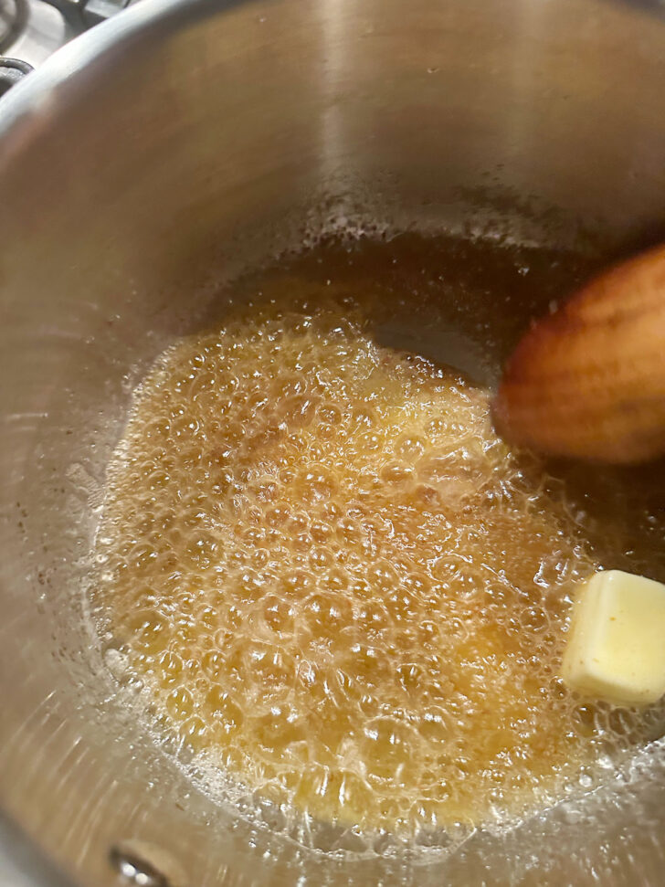 Adding additional butter to the saucepna.