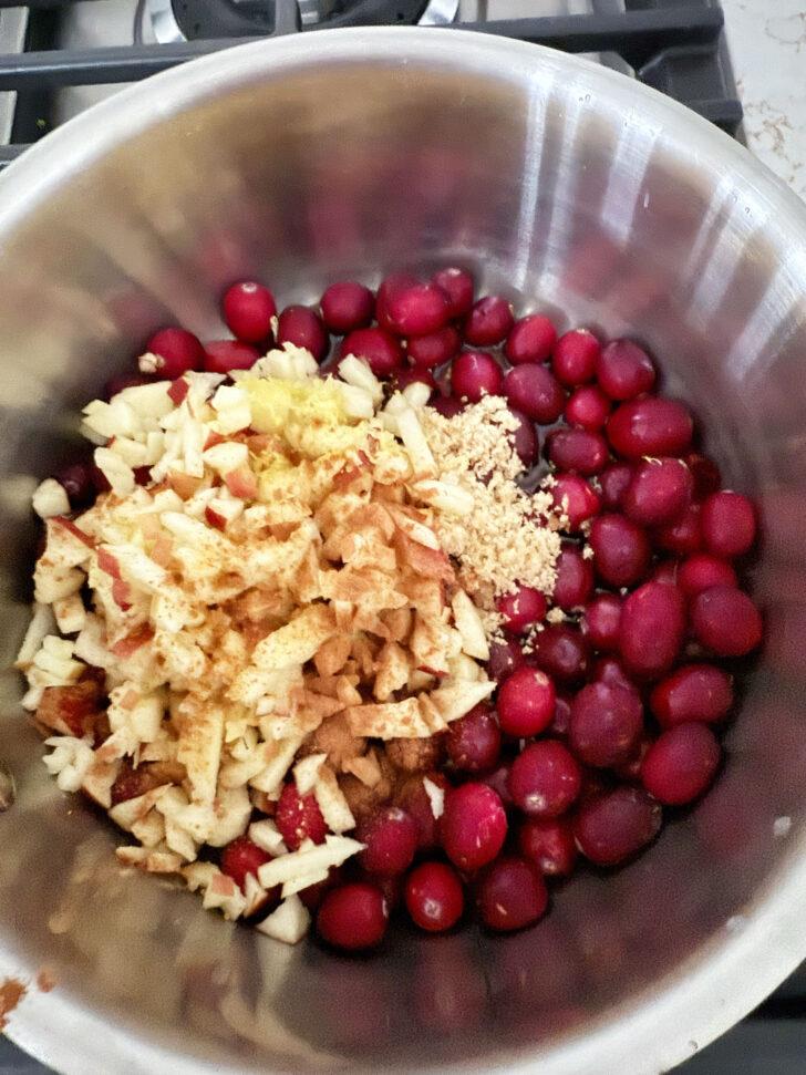 Cranberry apple glaze ingredients in a saucepan before cooking.