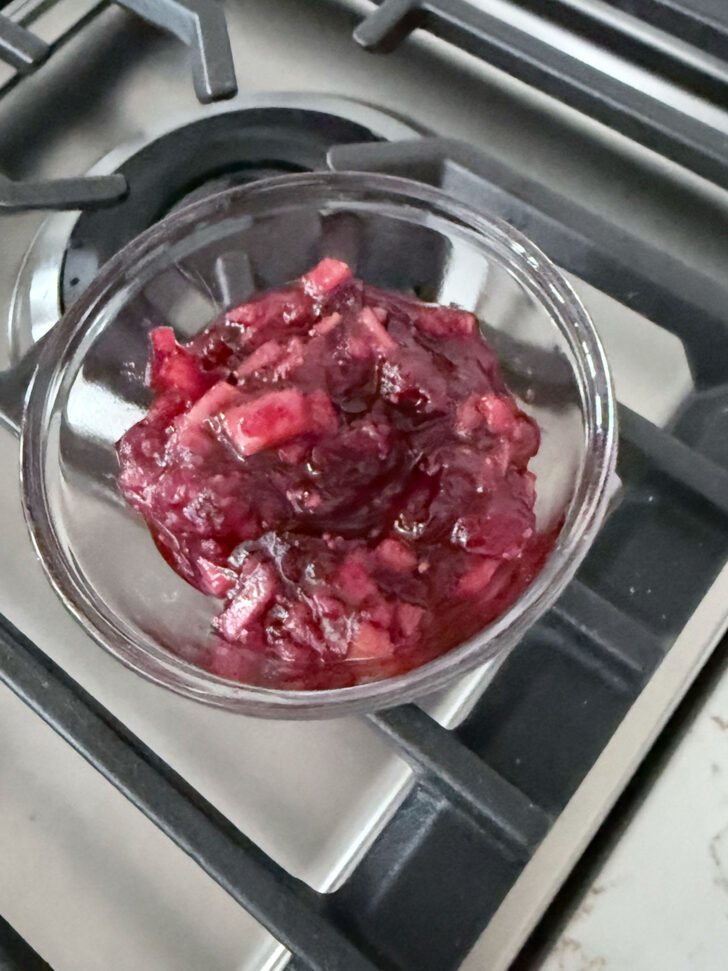 Setting aside some of the cranberry apple mixture for serving.