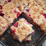Cranberry crumb bars cut in baking pan.