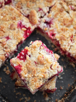 Cranberry crumb bars cut in baking pan.