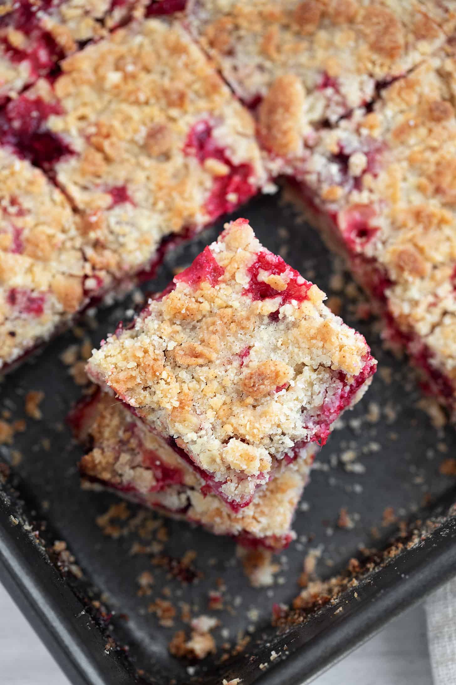 Cranberry crumb bars cut in baking pan.