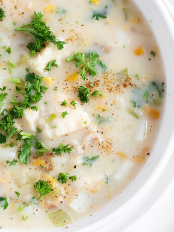 Cod chowder in a white bowl.