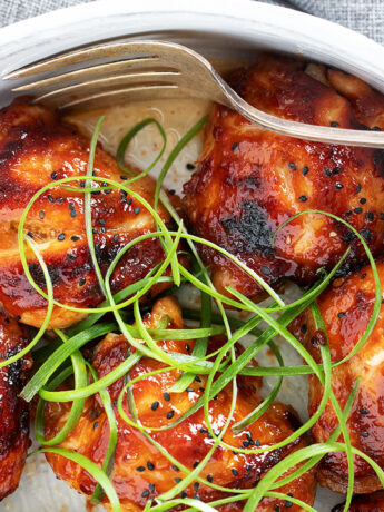 Honey soy chicken in a serving dish with a fork.