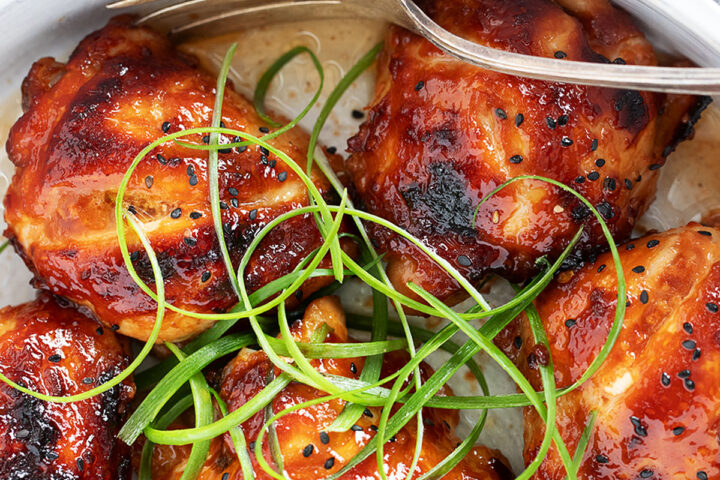 Honey soy chicken in a serving dish with a fork.