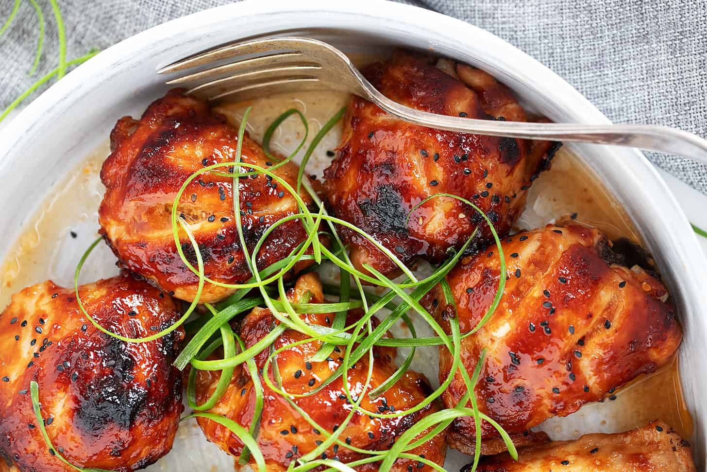 Honey soy chicken in a serving dish with a fork.