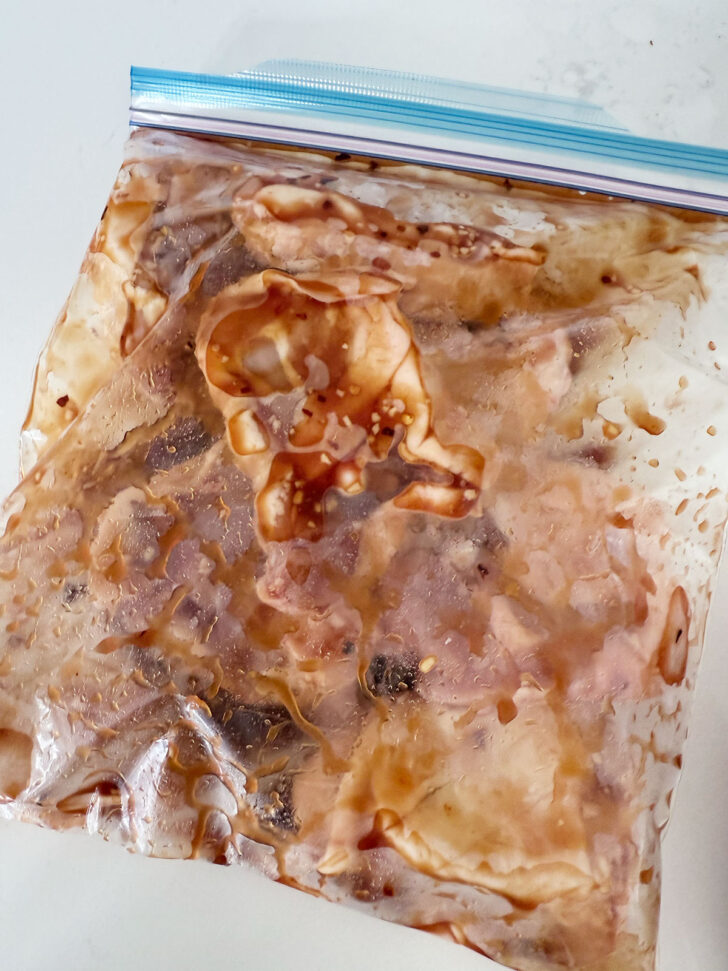 Marinating chicken in a plastic zip bag.