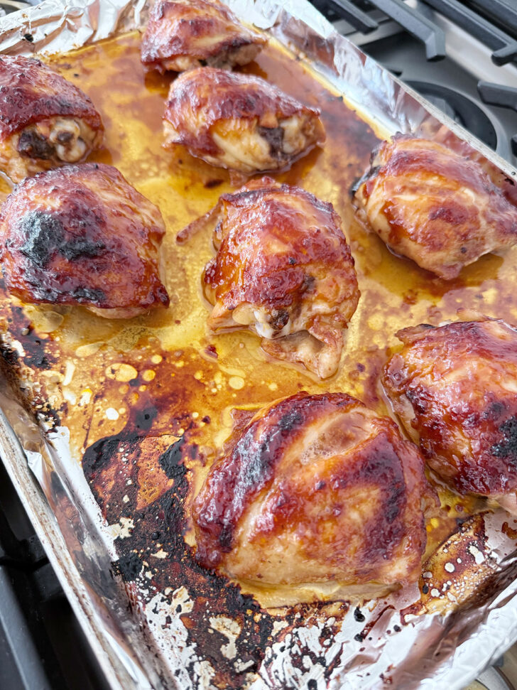 Finished honey soy chicken thighs on the baking sheet.