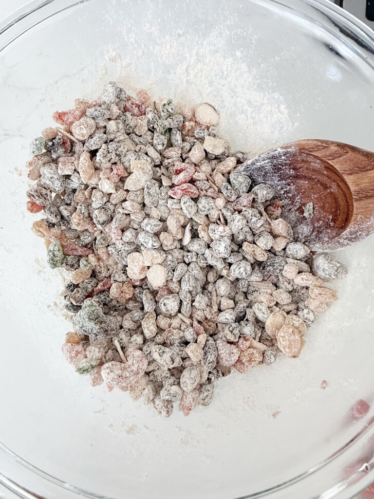 Dried fruit combined with the dry ingredients in a bowl.