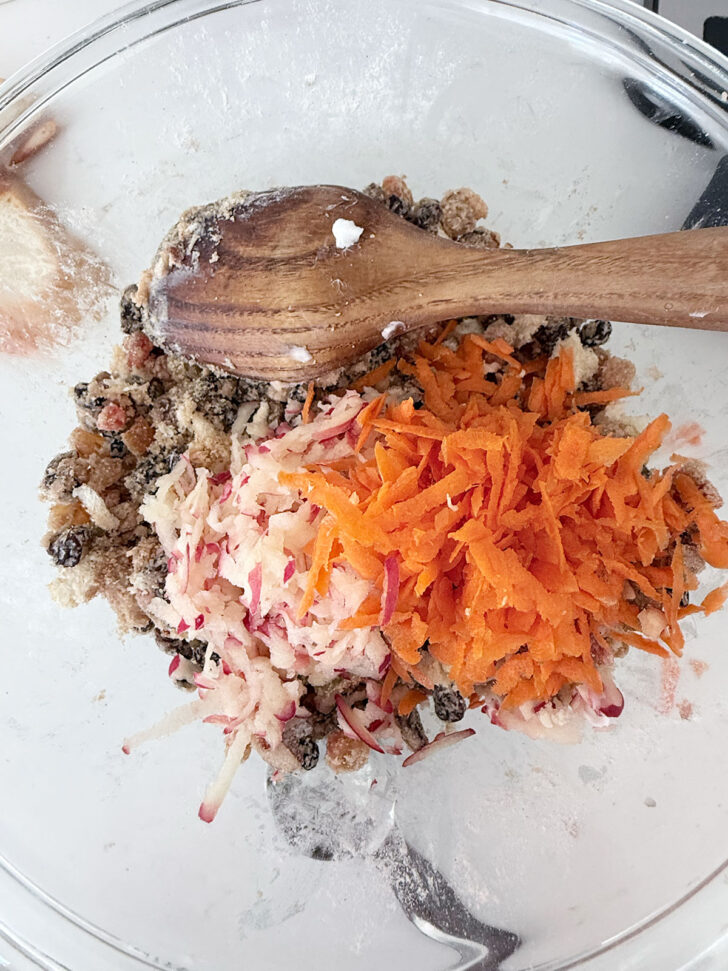 Grated apple and carrot added to the bowl.