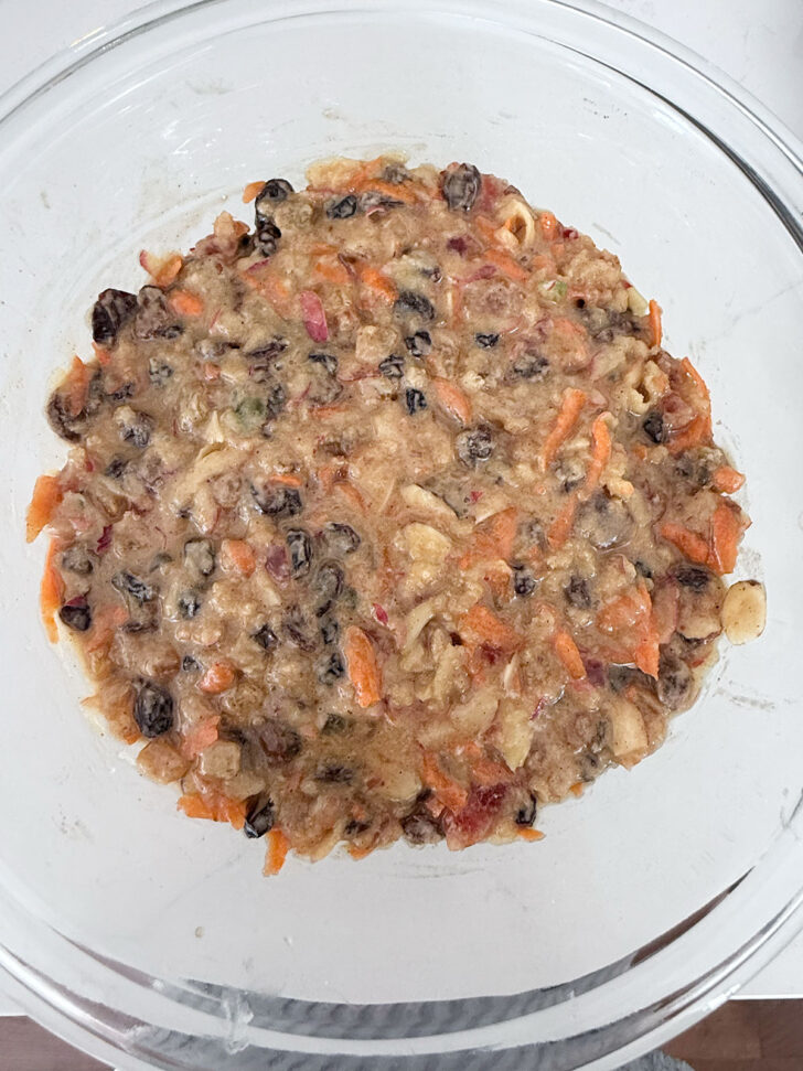 Christmas pudding batter spooned into a glass bowl.