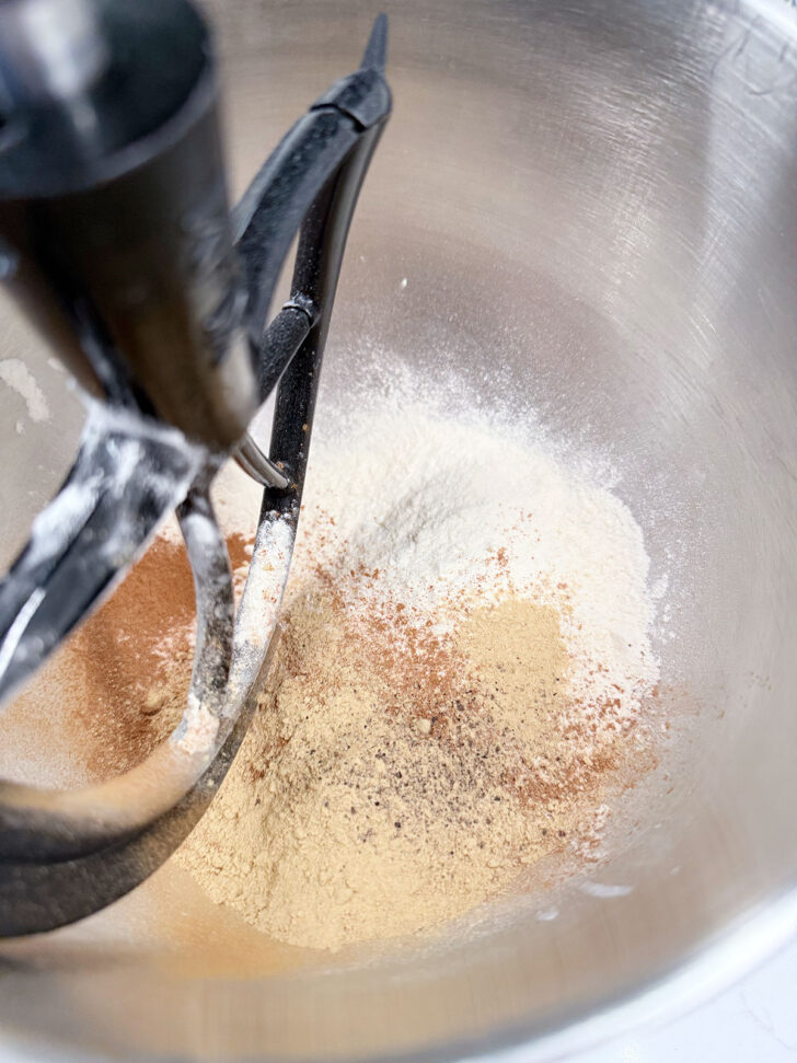Dry ingredients added to a stand mixer.