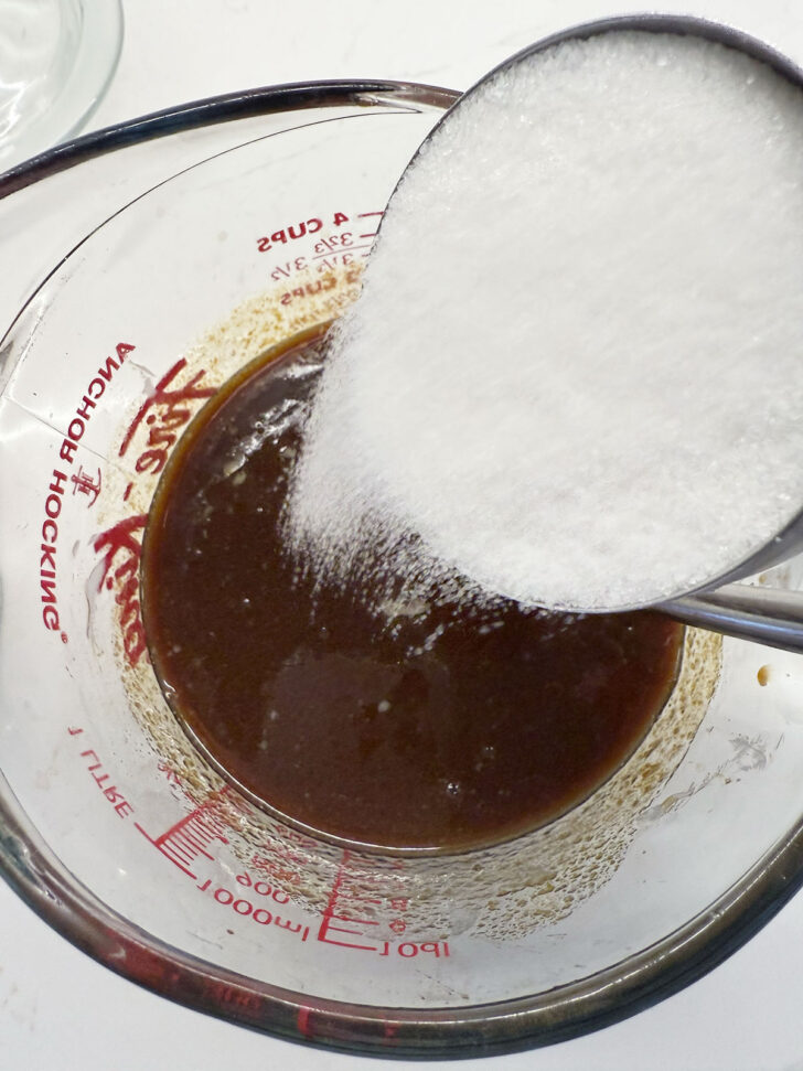 Adding white sugar to the milk and molasses mixture.