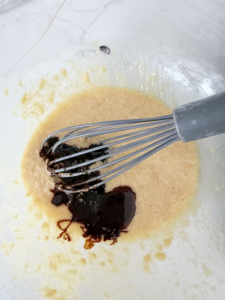 Adding the vanilla to the pudding batter.