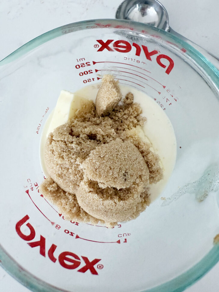 Adding the toffee sauce ingredients to a glass measuring cup.