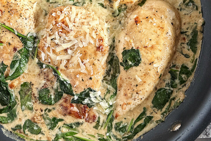 Chicken Florentine in a skillet.