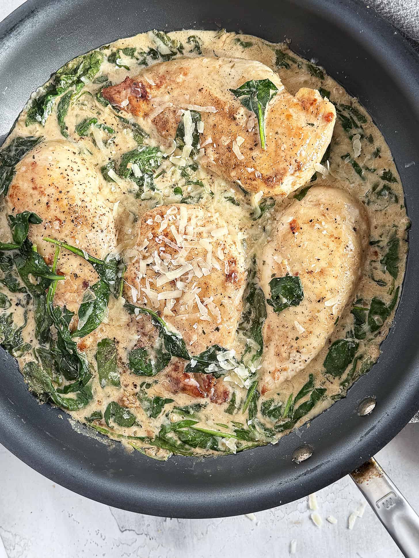 Chicken Florentine in a skillet.