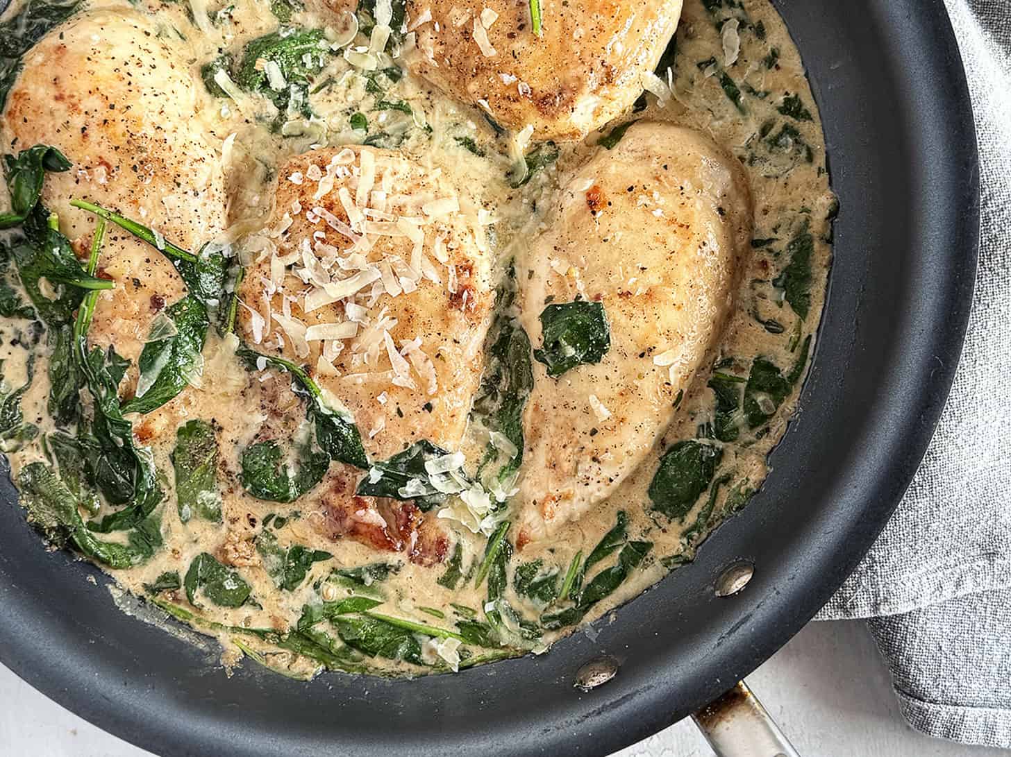 Chicken Florentine in a skillet.
