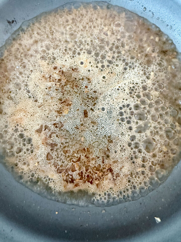 Skillet after wine was added to deglaze.