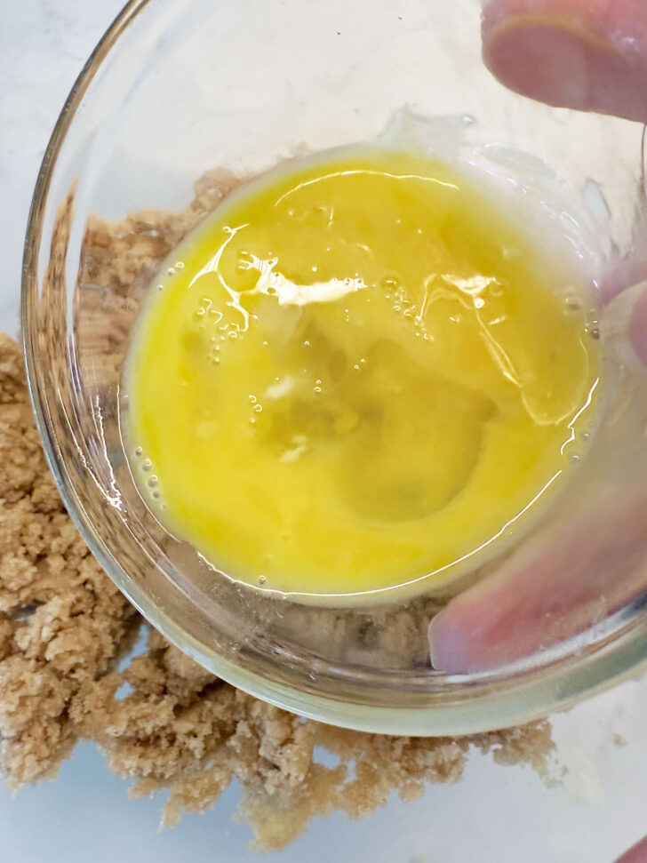 Adding egg to the brown sugar and butter mixture.