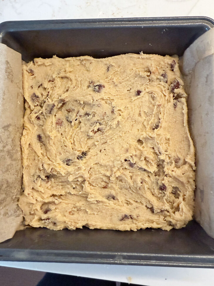 Batter spread into a parchment-lined baking pan.