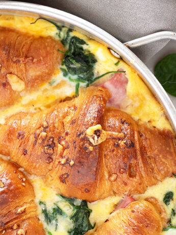 Ham and cheese croissant bake in pan.
