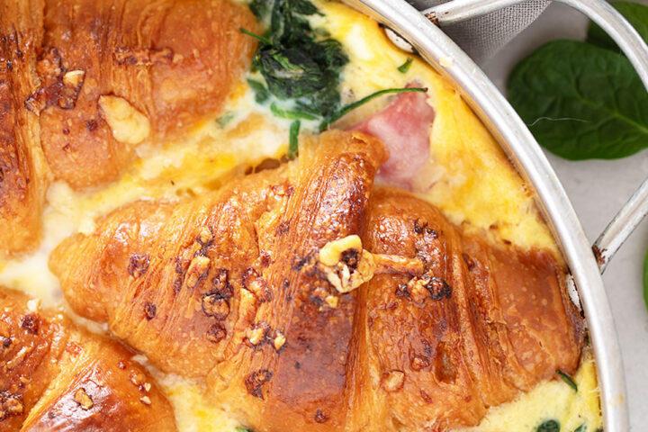 Ham and cheese croissant bake in pan.