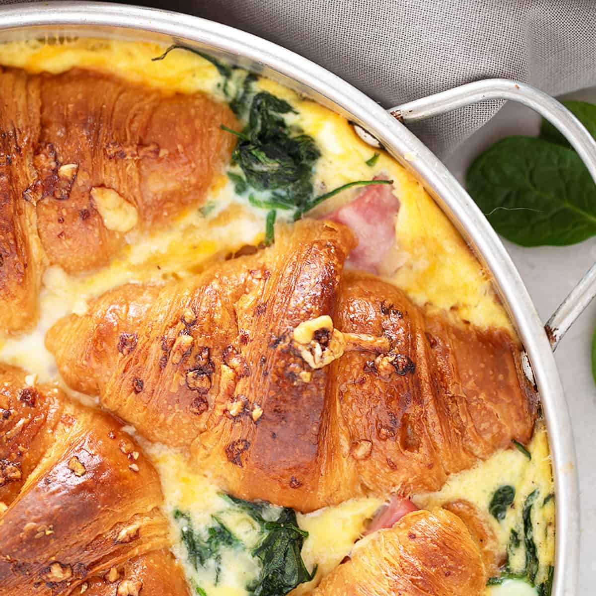 Ham and cheese croissant bake in pan.