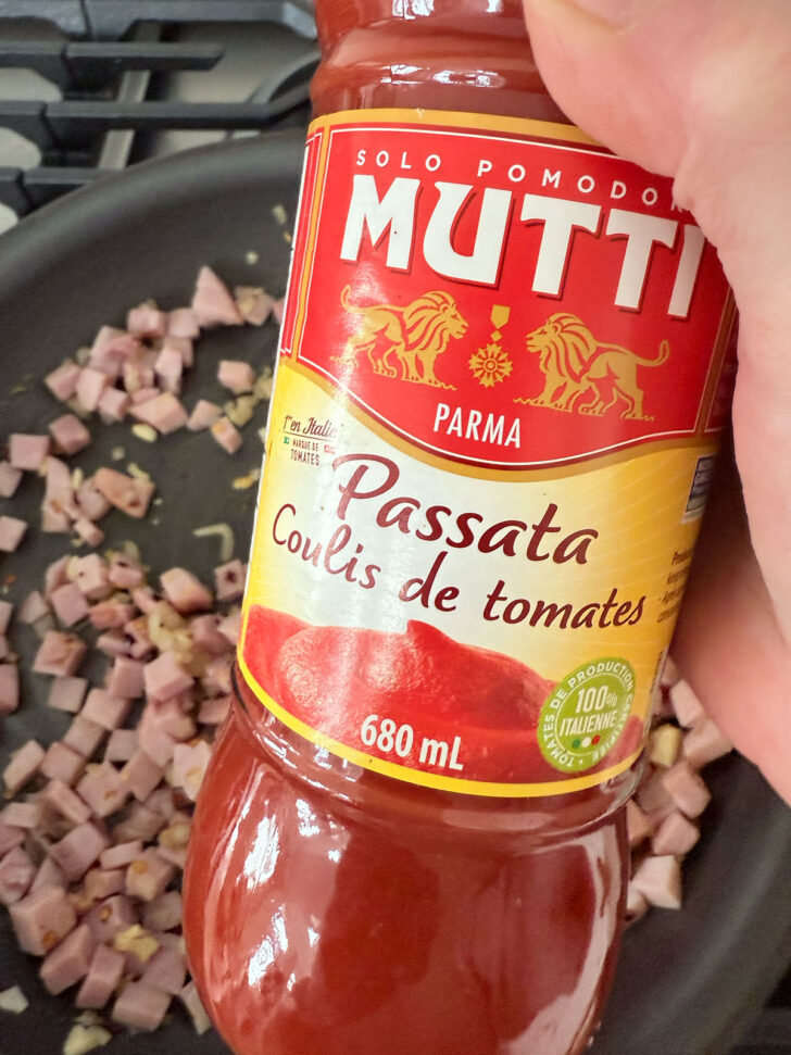 Jar of passata ready to go into the pan.
