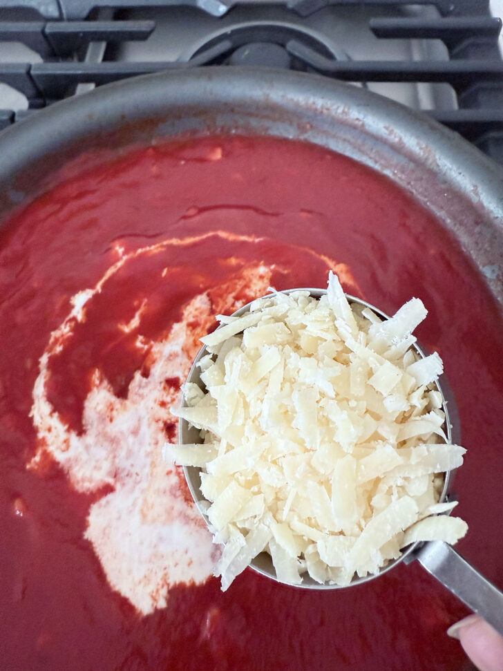 Adding the cream and Parmesan to the sauce.