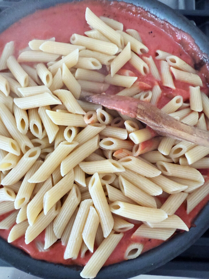 All the pasta added to the pan.