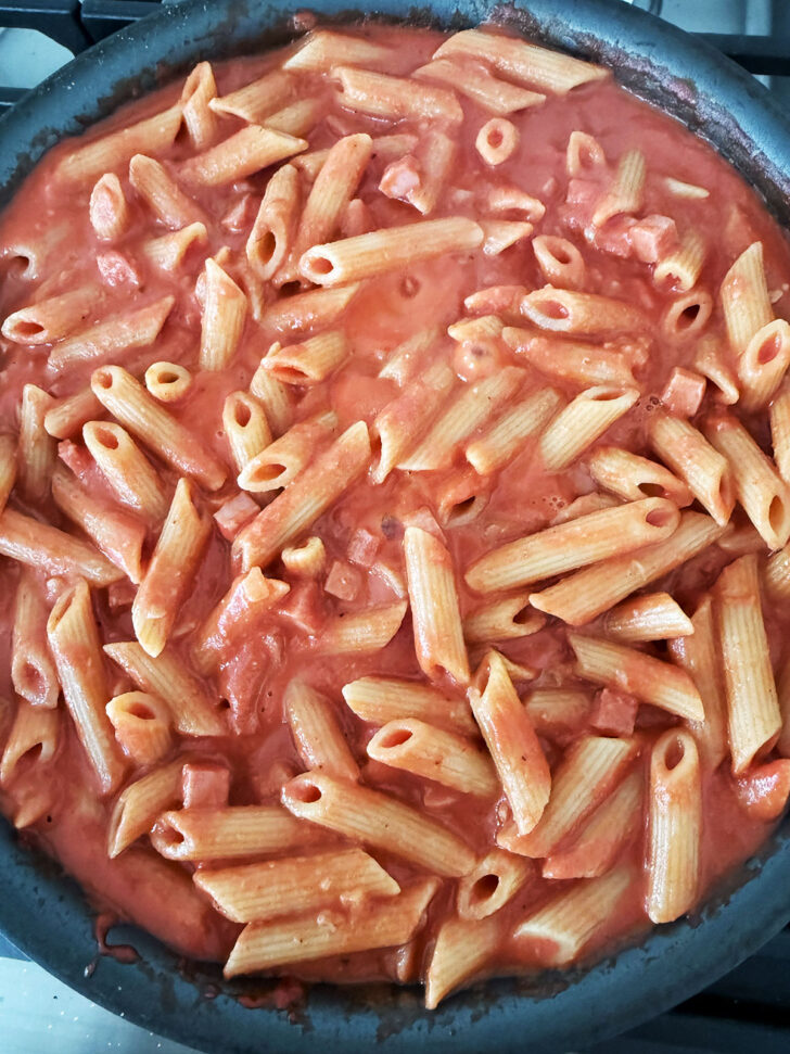 Finished ham and tomato pasta in the skillet.