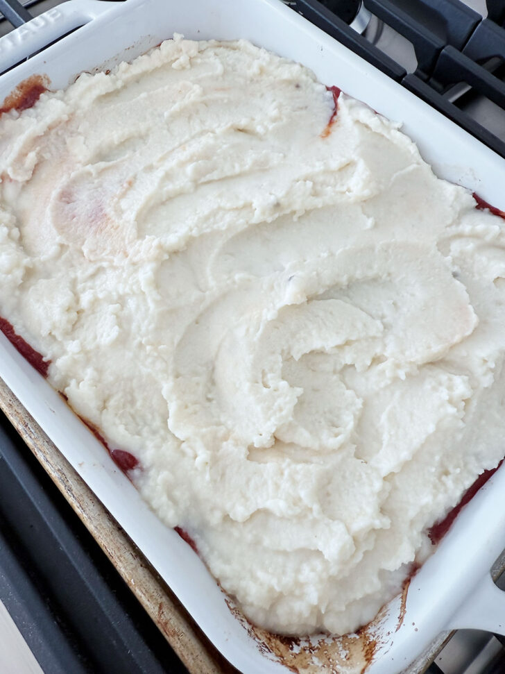 Mashed potatoes spread over the casserole.