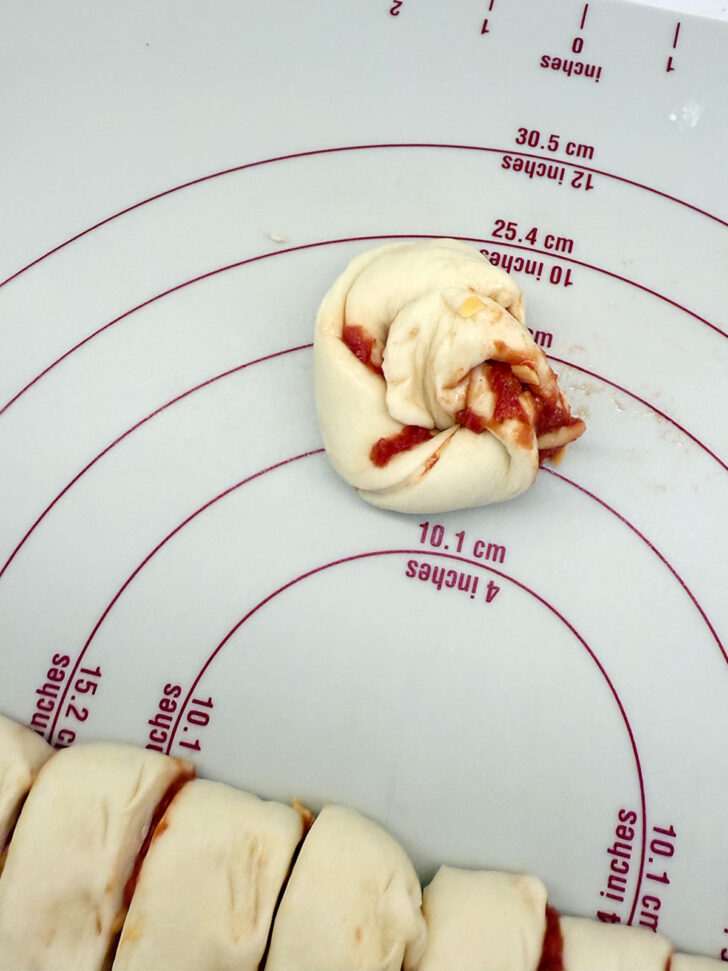 Coiling up the dough strips into a knot.