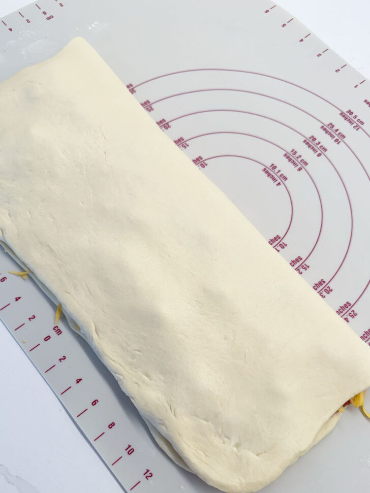 Empty side of the dough rectangle folded over the filled side.