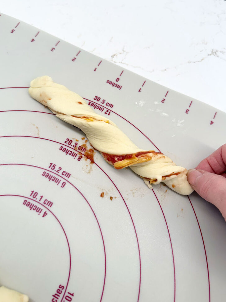 Twisting the dough strips.