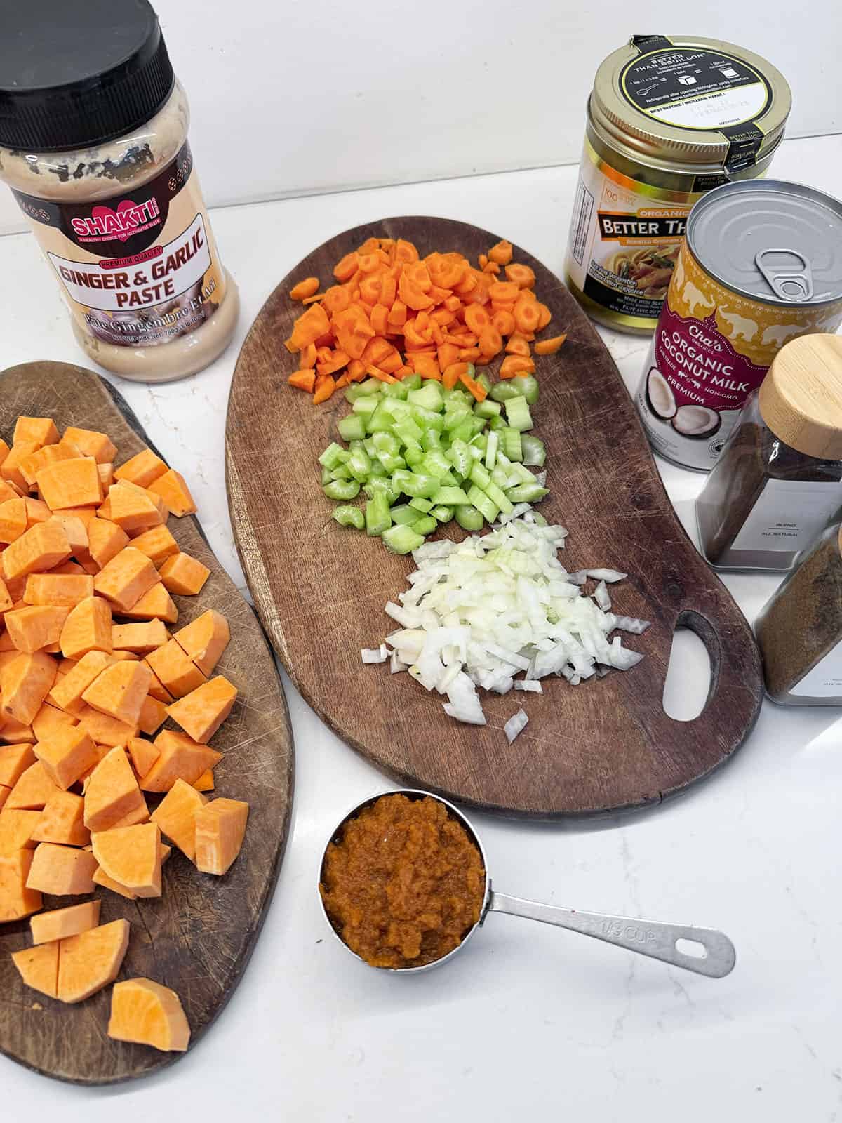 Ingredients laid out for a sweet potato coconut curry soup.