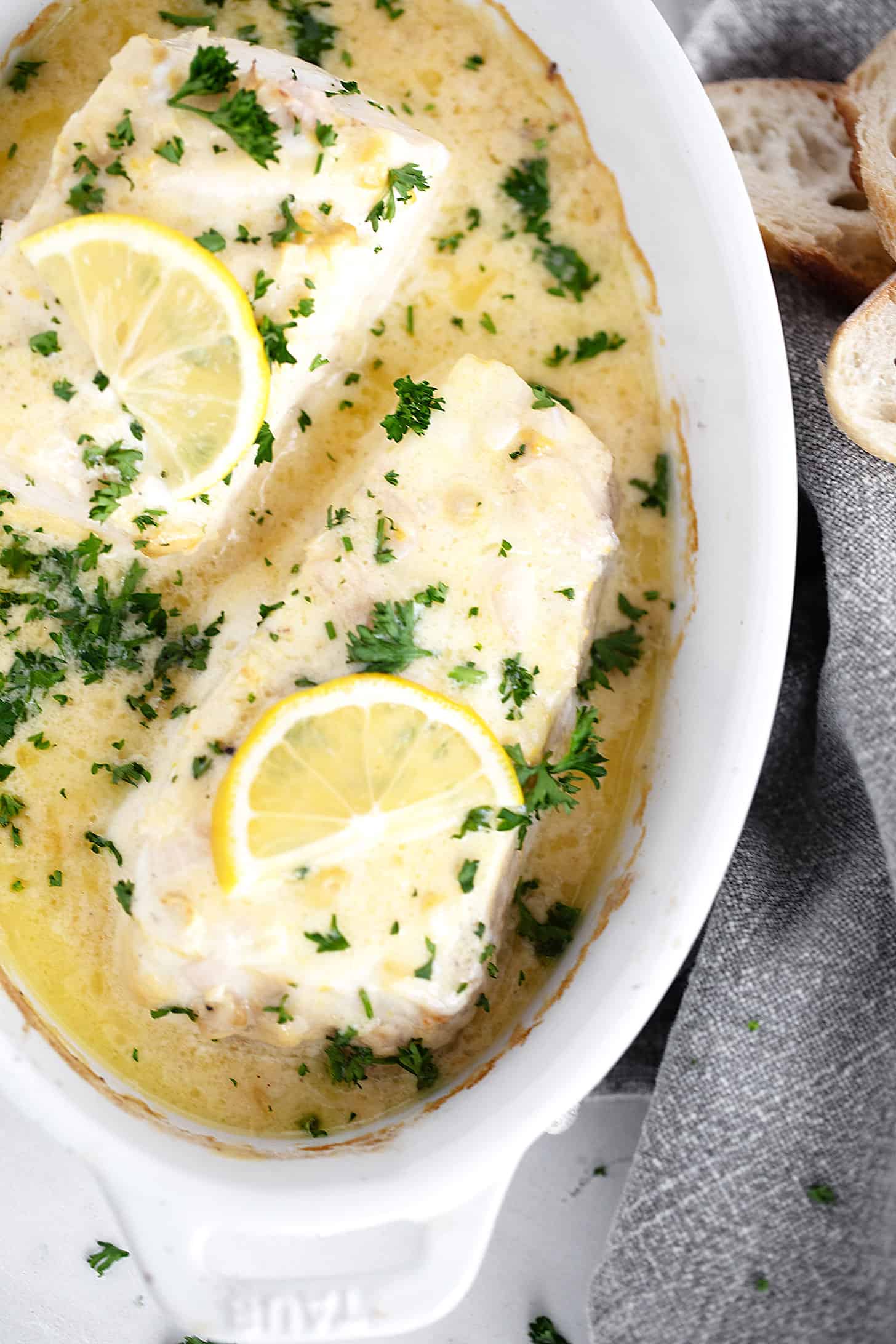 Creamy lemon baked halibut in serving dish.