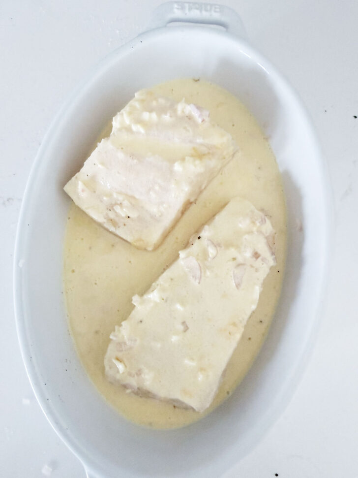 Creamy lemon baked halibut ready for the oven.