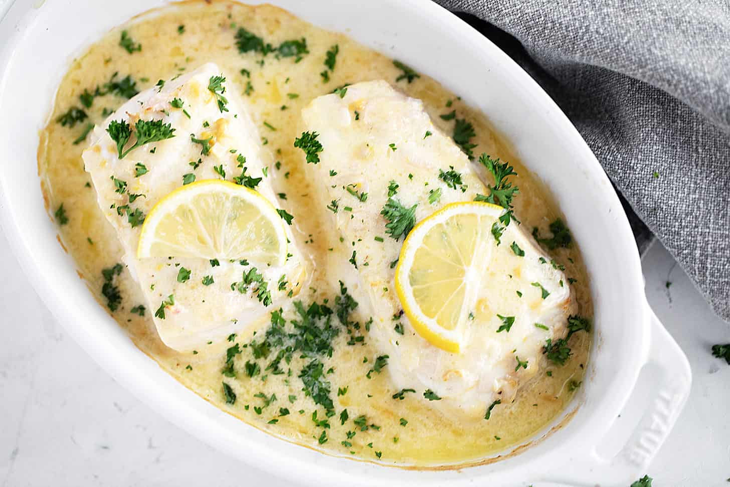 Creamy lemon baked halibut in the baking dish.
