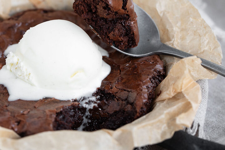 Snacking brownie in a small cast iron skillet.