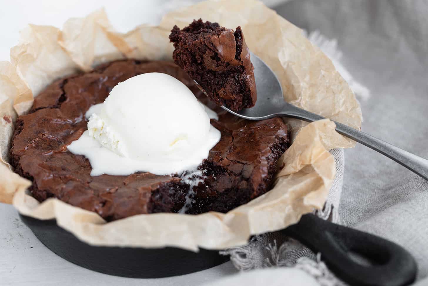 Snacking brownie in a small cast iron skillet.