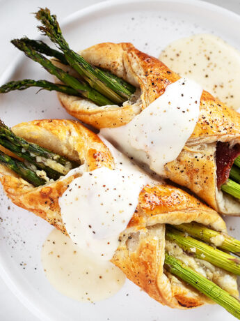 Asparagus filled puff pastry and prosciutto with cheese sauce.