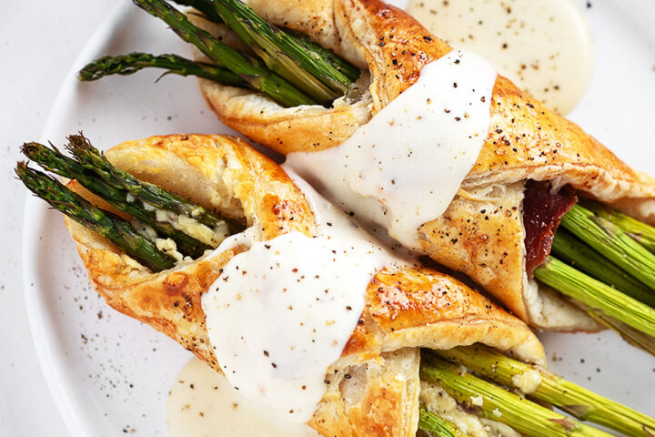 Asparagus filled puff pastry and prosciutto with cheese sauce.