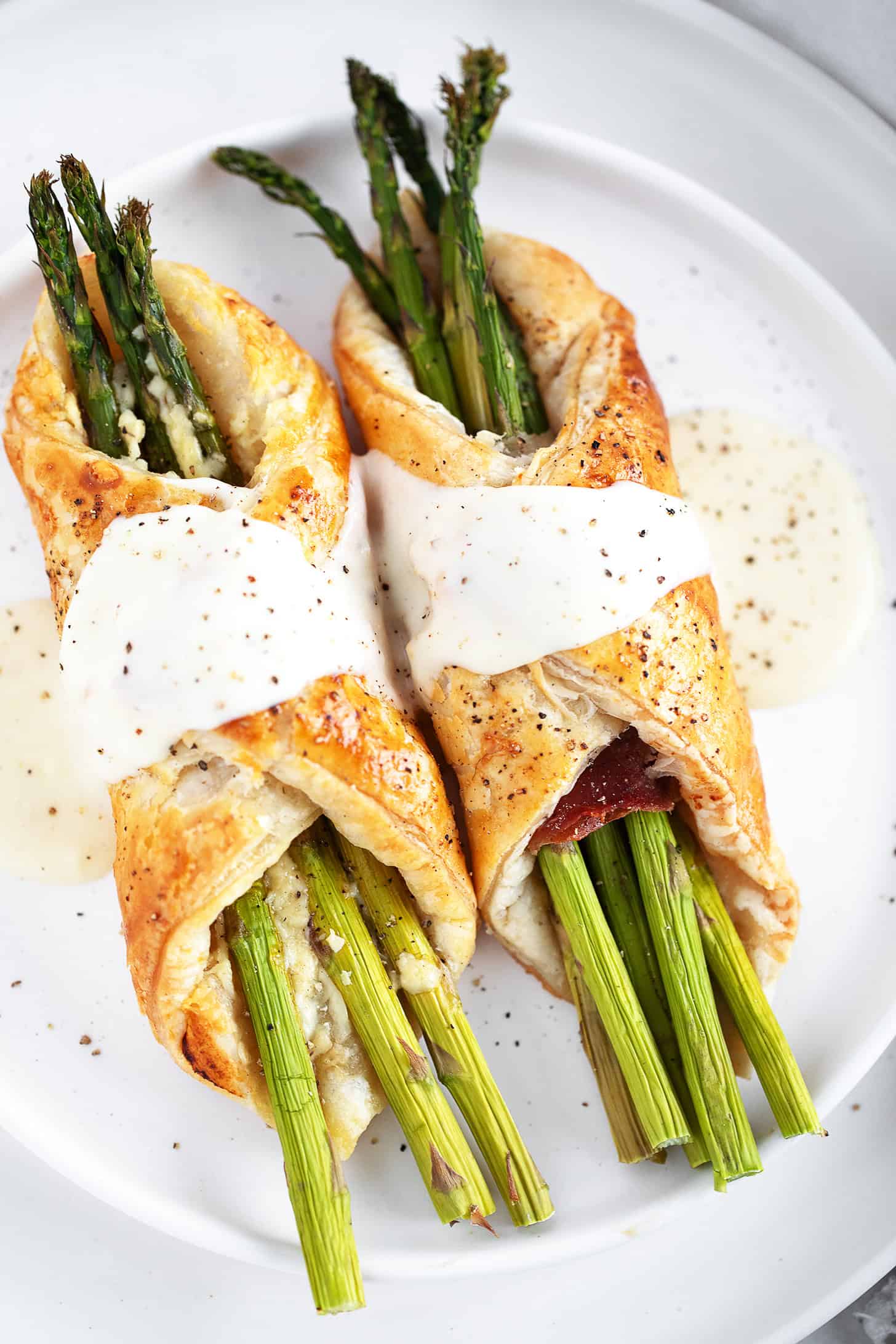 Asparagus filled puff pastry and prosciutto with cheese sauce.