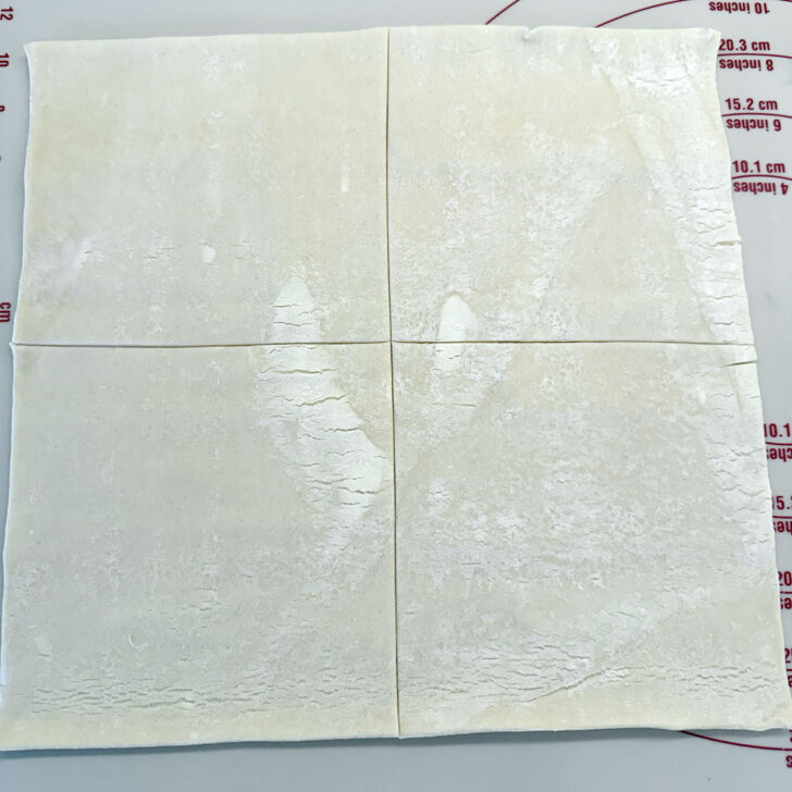 A sheet of puff pastry cut into 4 pieces.