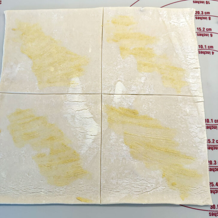Dijon mustard brushed on the puff pastry.